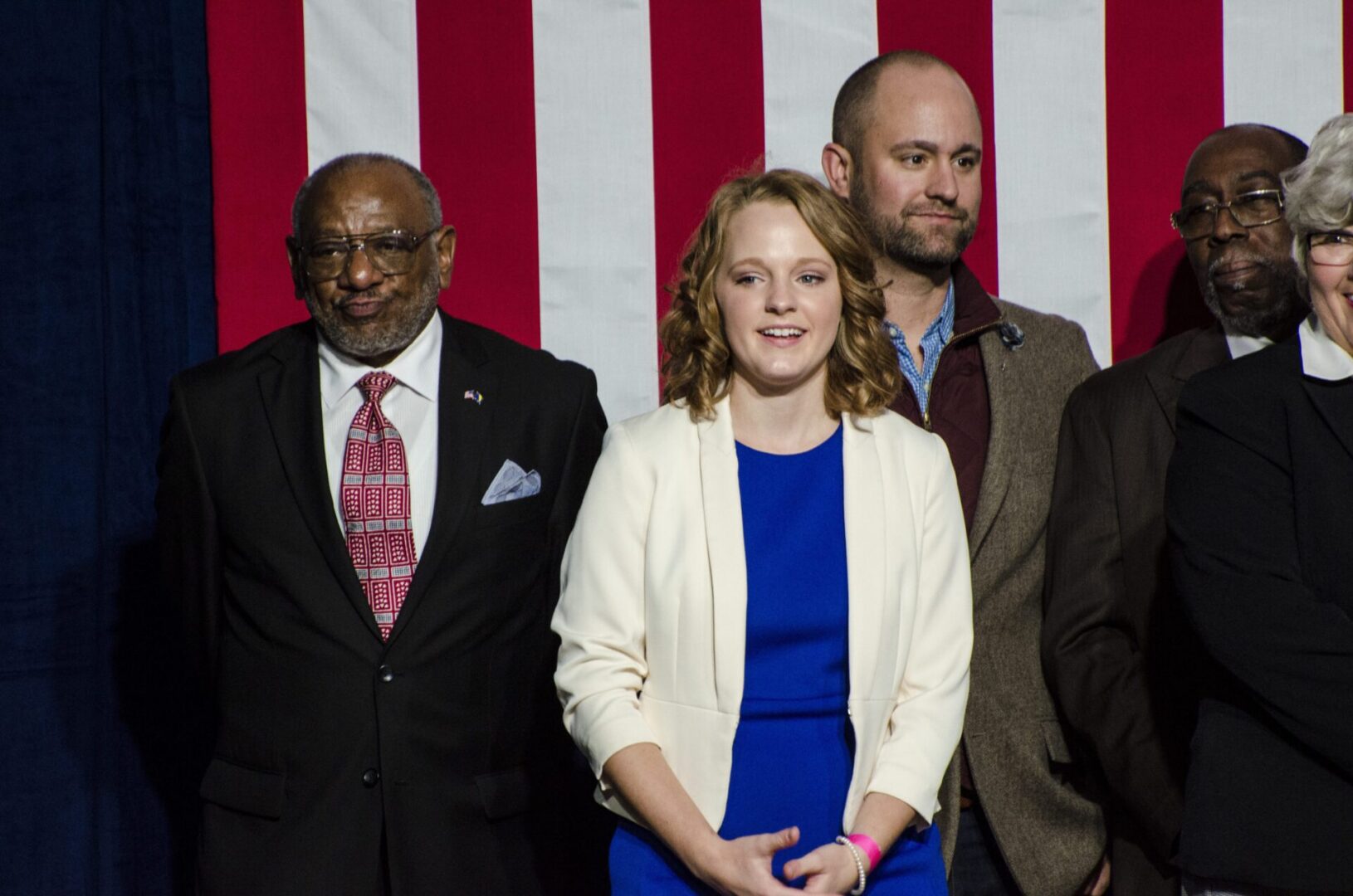 Group of people in front of flag