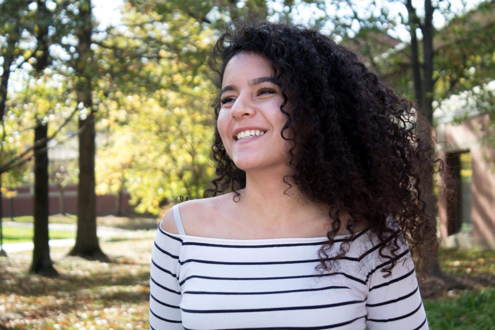 Happy woman with curly hair outside