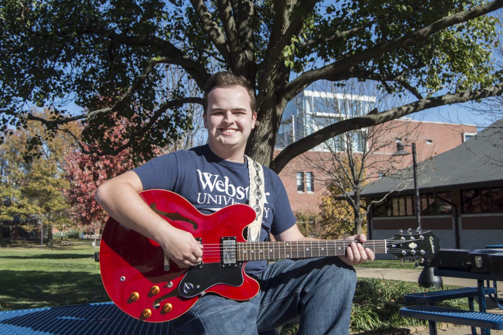 Outdoor music session with red guitar
