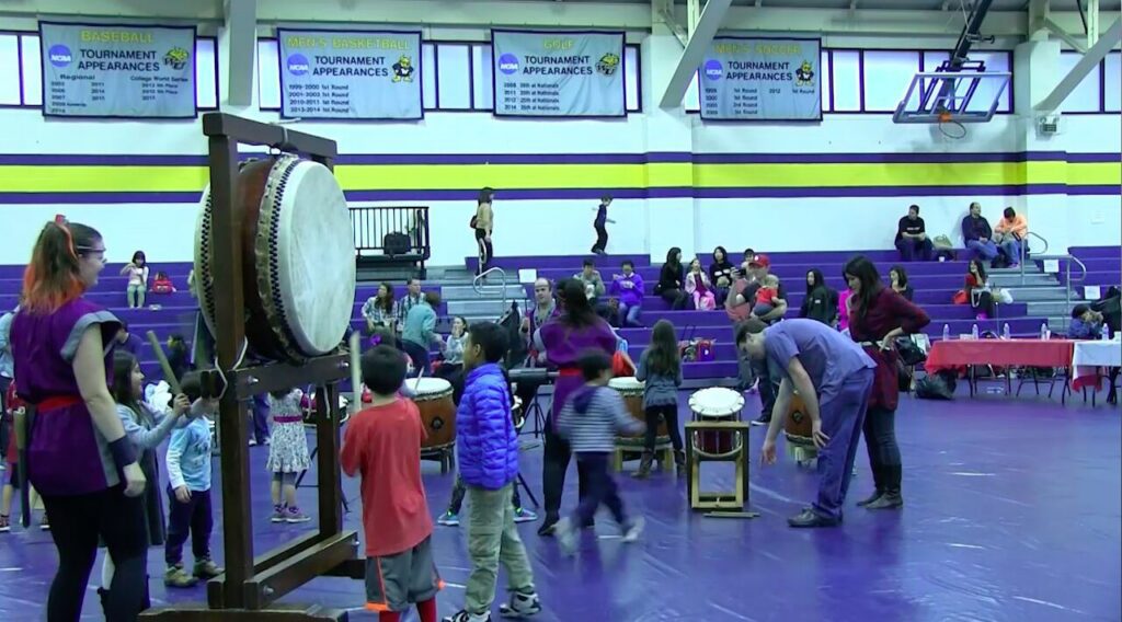 Kids participating in a drumming event