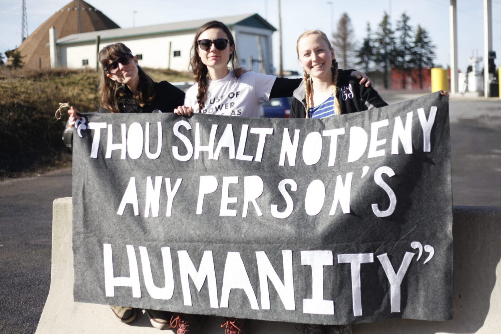 Group displaying a powerful message sign