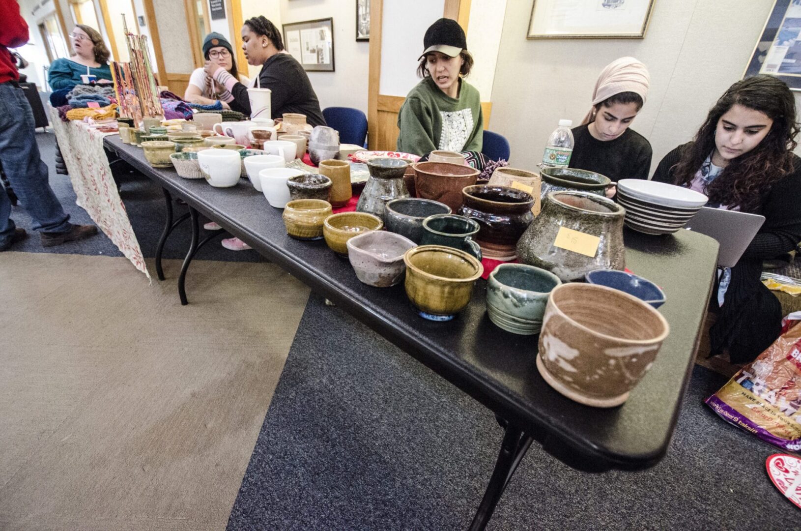 Assorted handmade pottery on black table