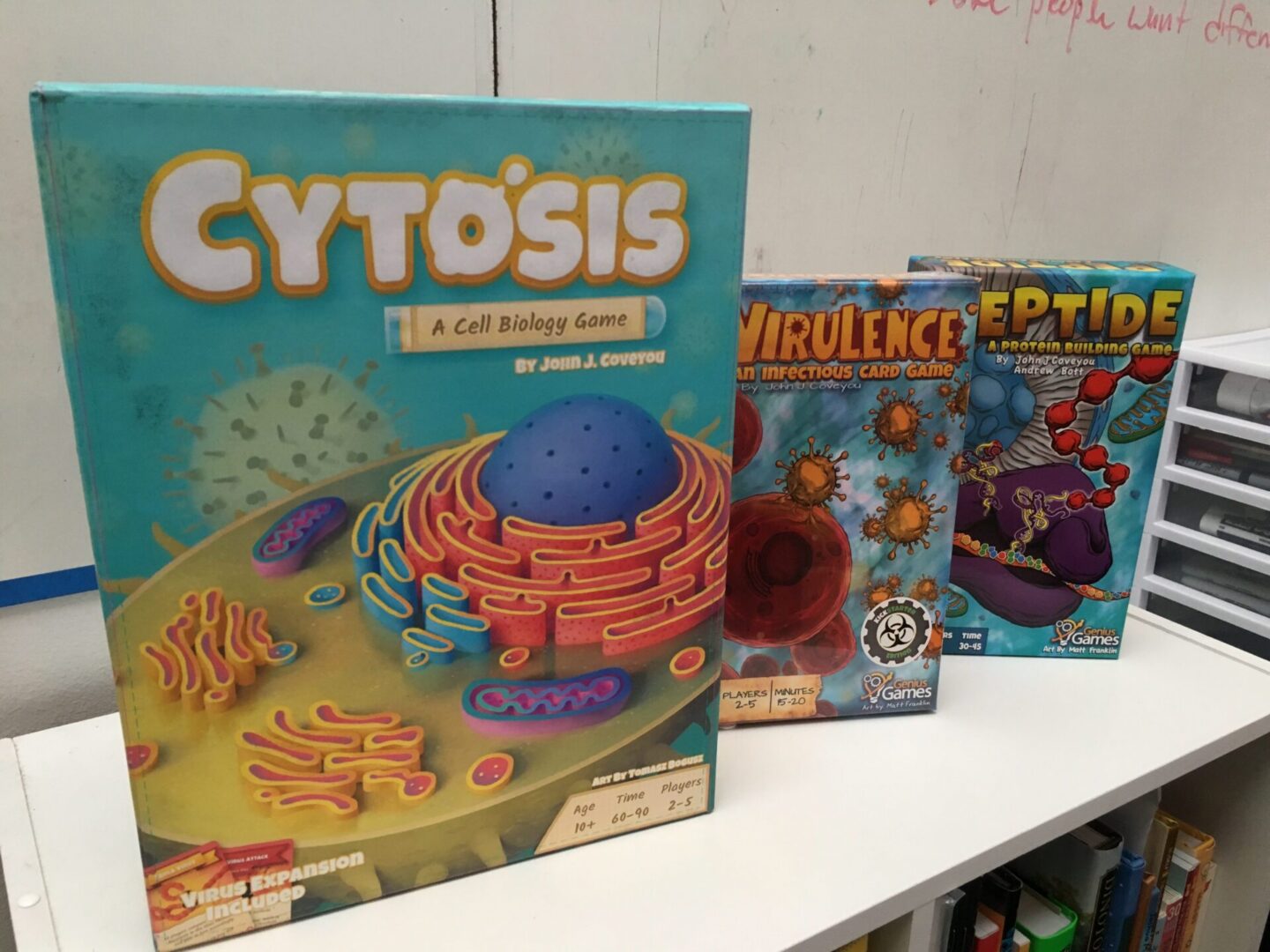 Cell biology board games on shelf
