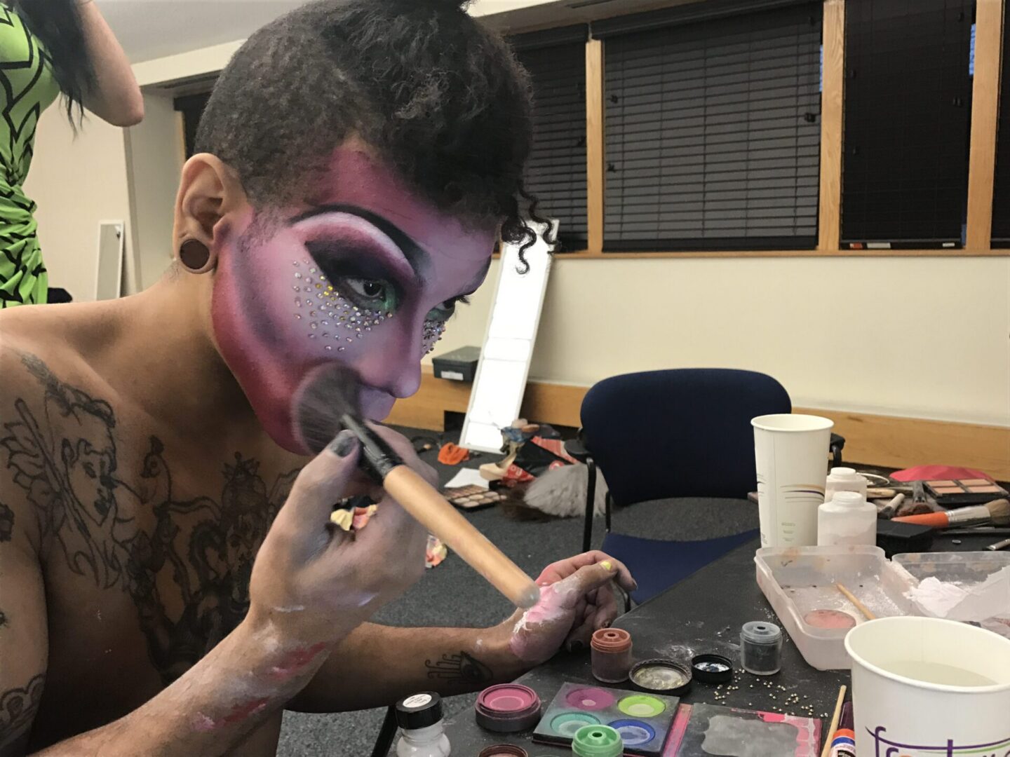 Drag artist doing makeup preparation