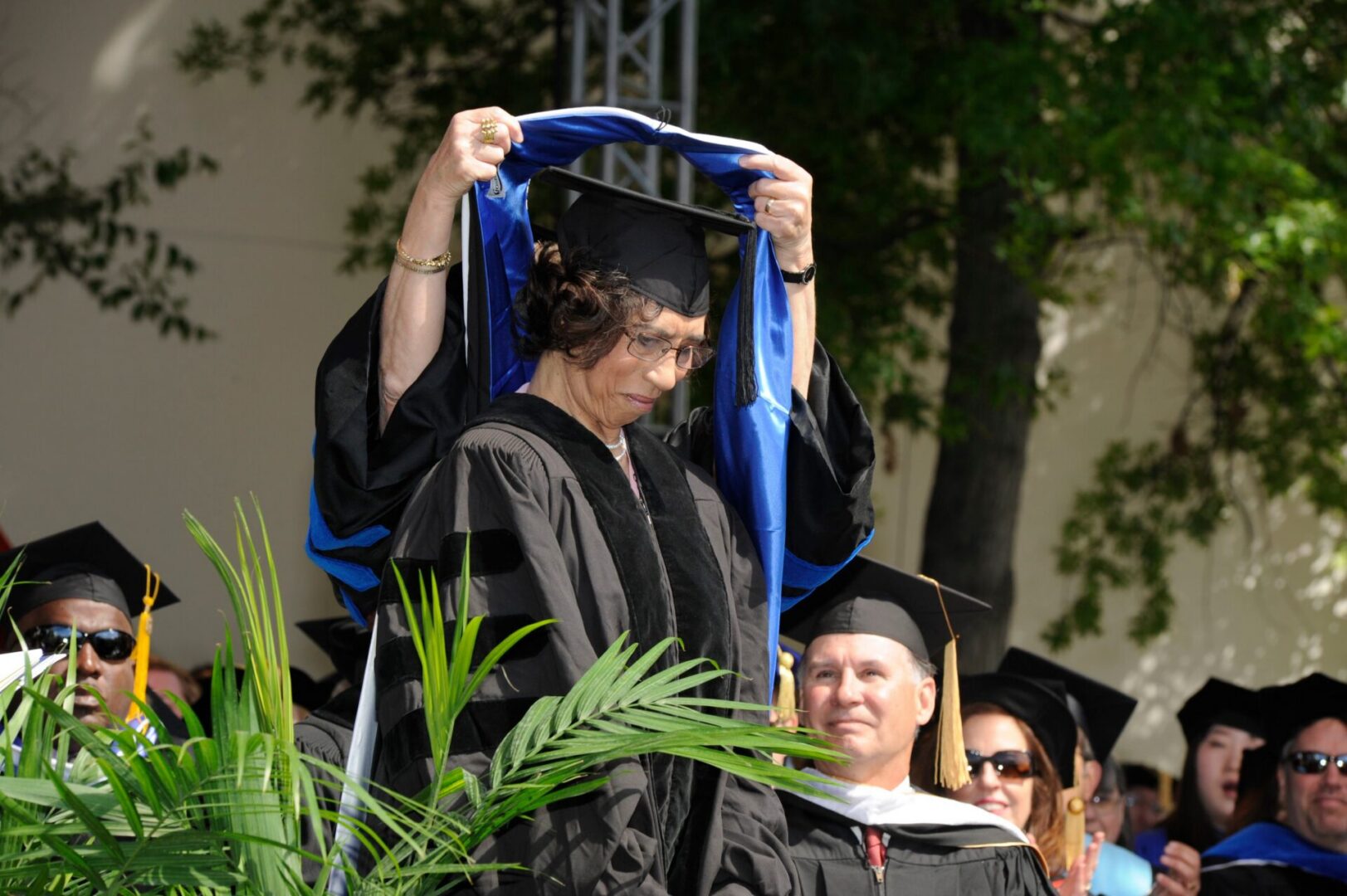 Graduate receiving doctoral hood outdoors