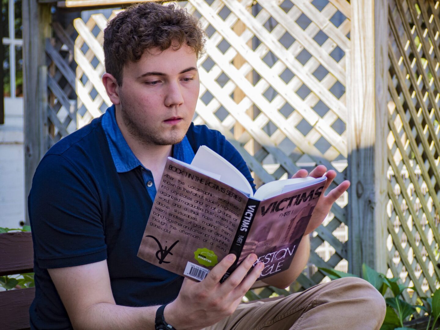 Man reading a book outdoors