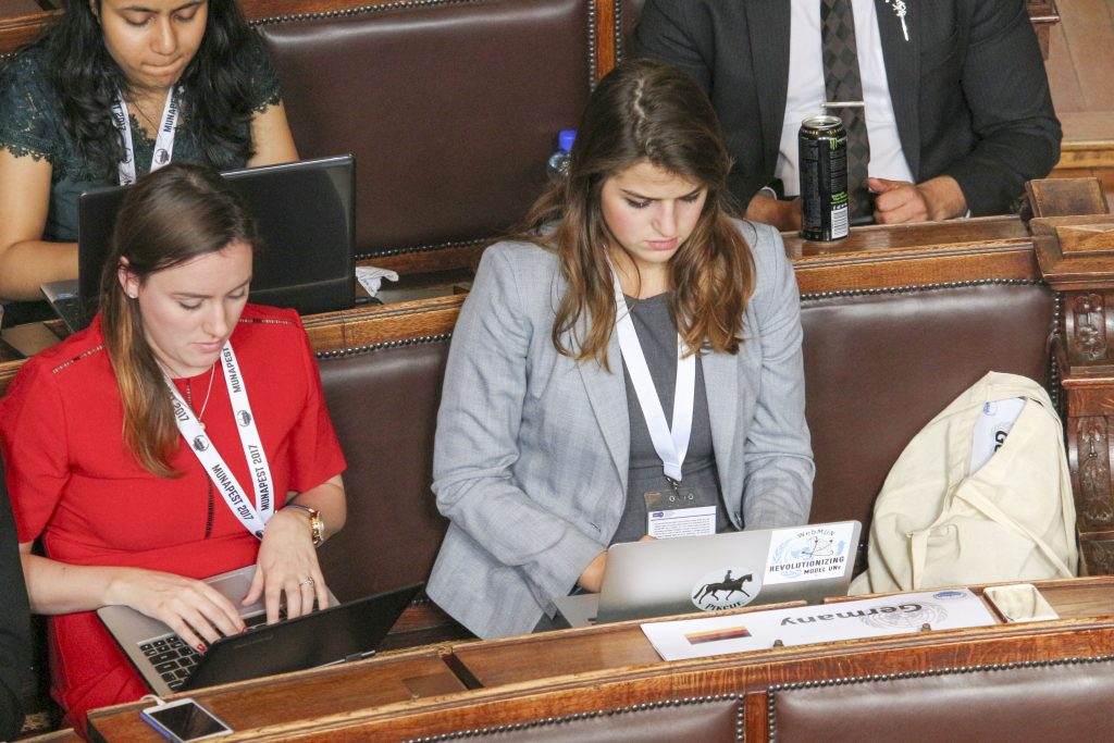Students Oliviana Bailey (left) and Vesna Ratkovic (right) review amendments on the floor of the Munapest General Assembly in Budapest April 14. BRIAN RUTH / The Journal