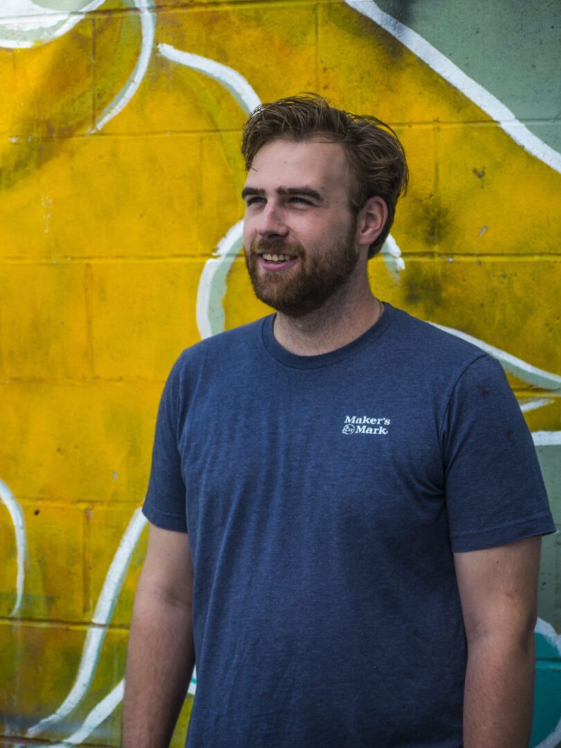 Man in blue shirt smiling outdoors