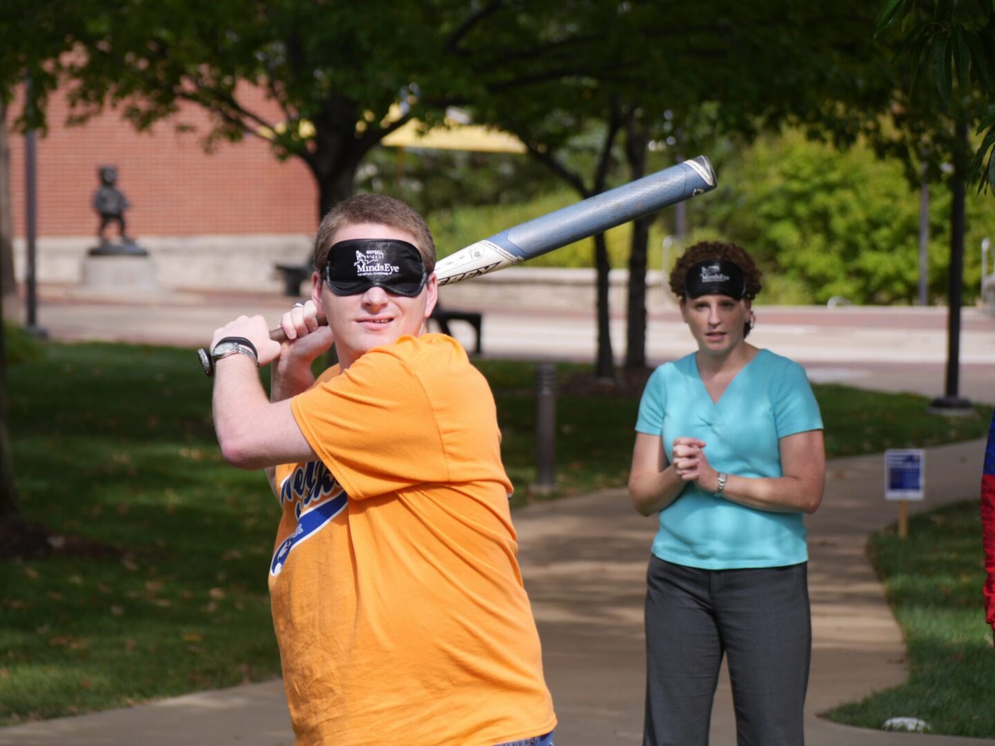 People participating in blindfolded baseball activity