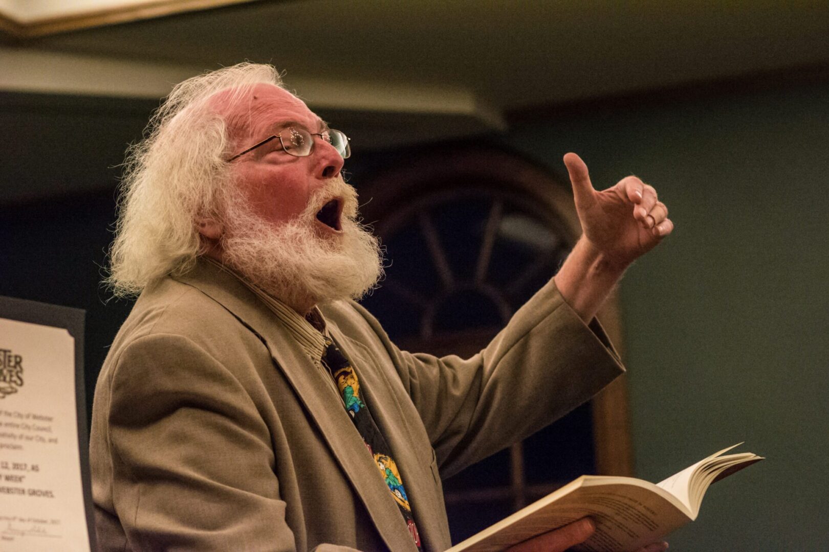 Bearded man giving an animated lecture