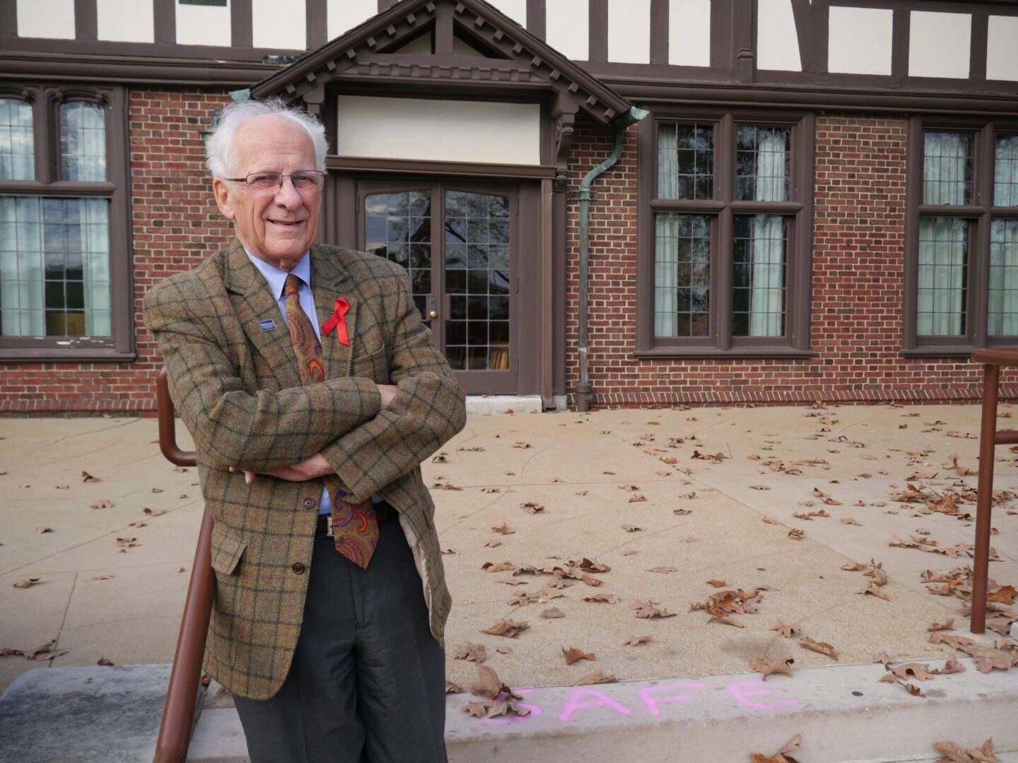 Senior in plaid jacket on sidewalk