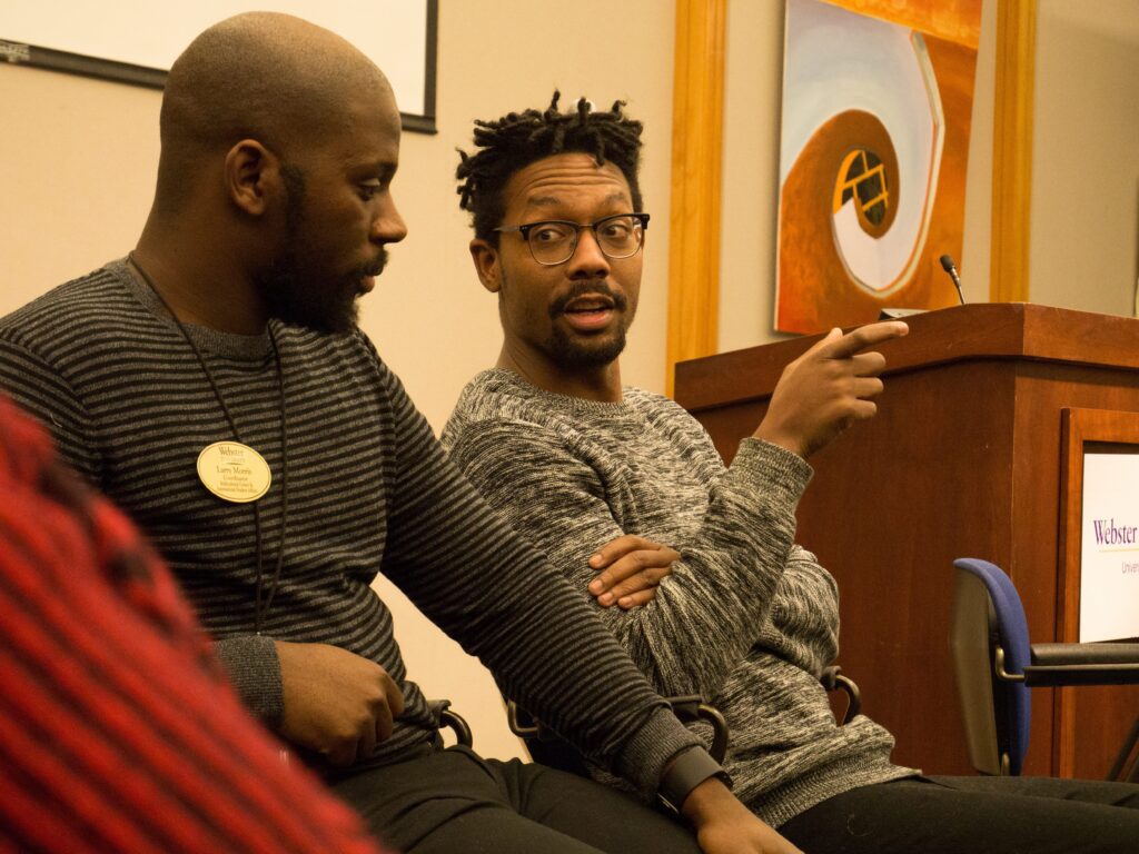 Engaged conversation between two seated men.