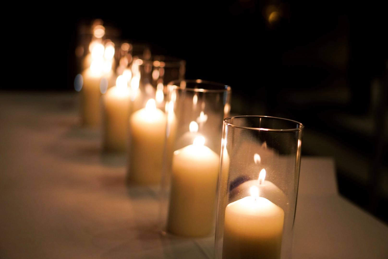 Candles glowing in glass holders