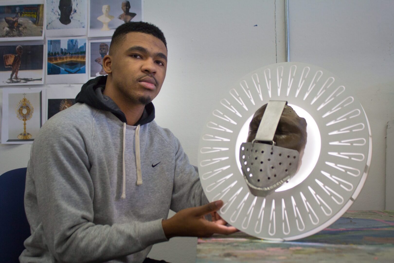 Man showcasing artistic mask creation