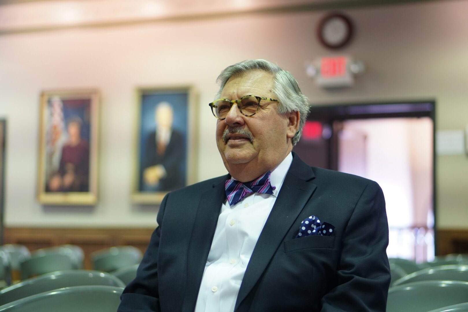 Man in suit with bowtie sitting