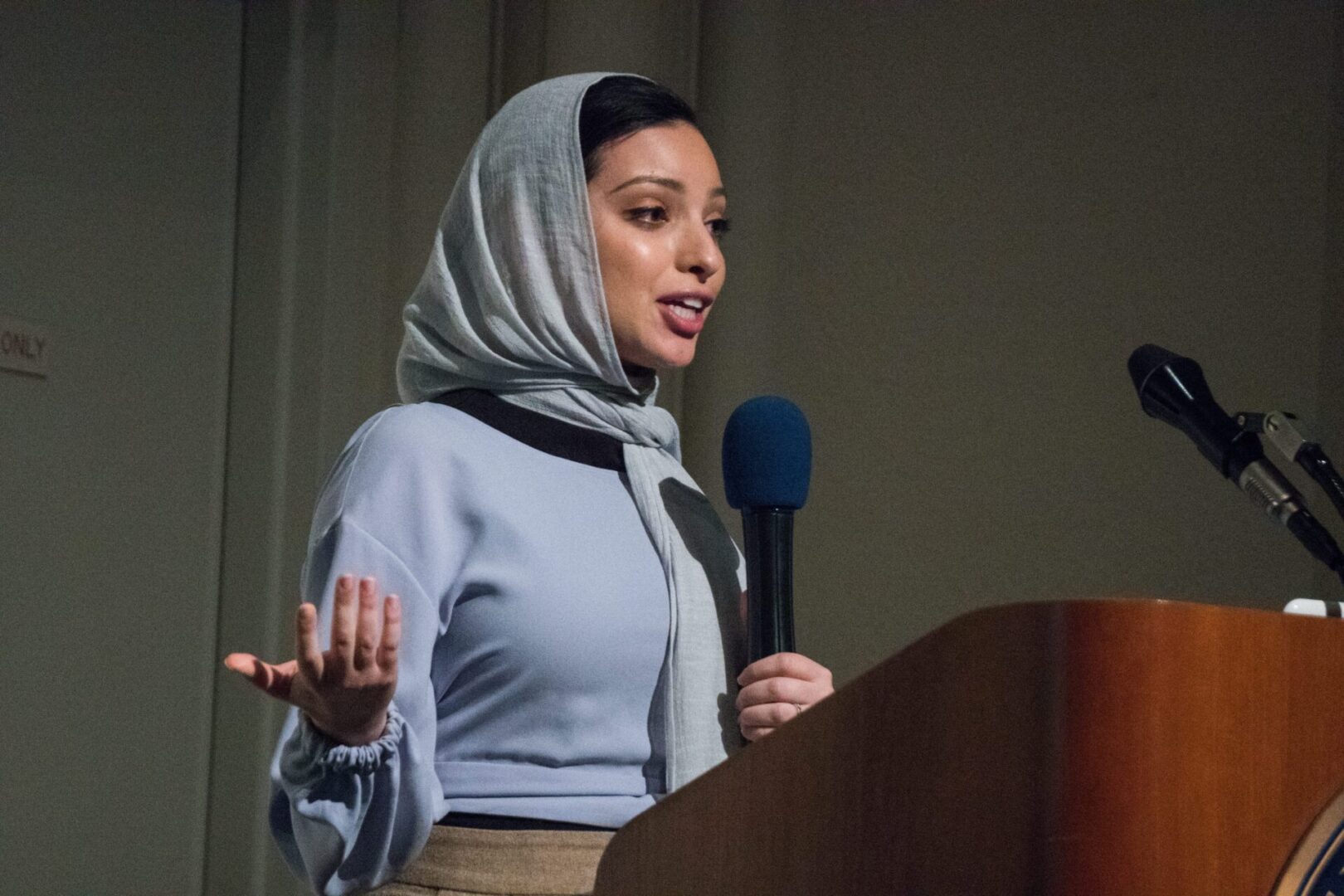 Woman delivering a speech in a hijab