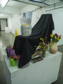 Flowers and art history books adorn the student-created shrine in the Visual Arts Studio.