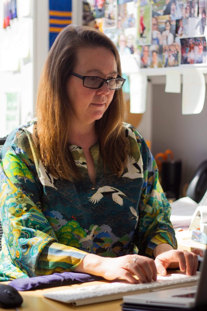 Woman typing at a desk