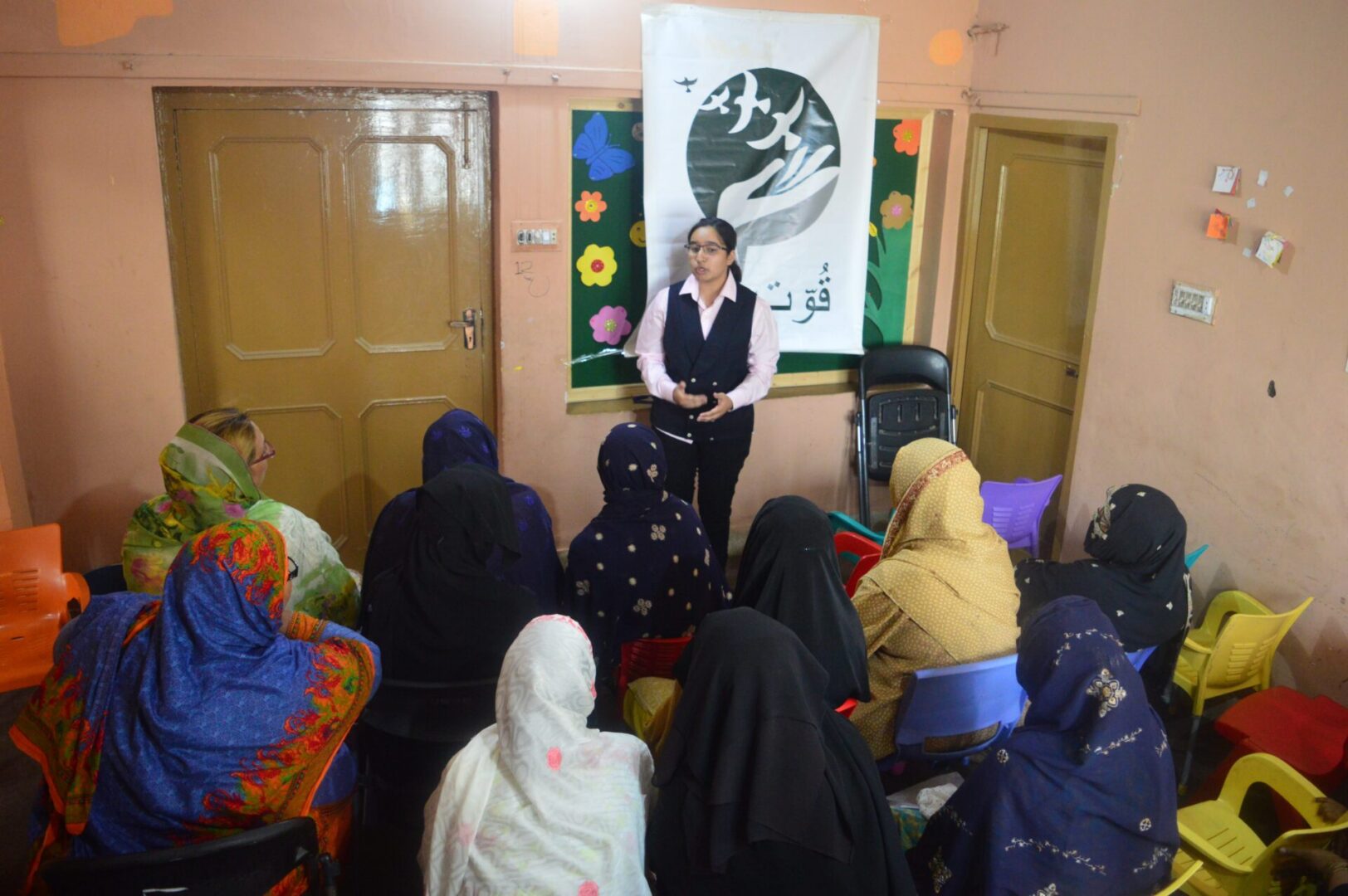 Instructor speaking to seated women