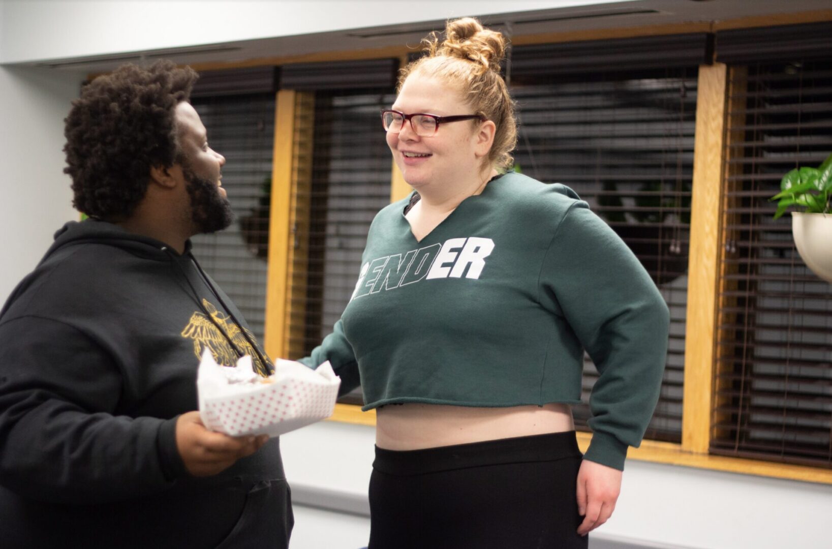 Man holding food, woman smiling