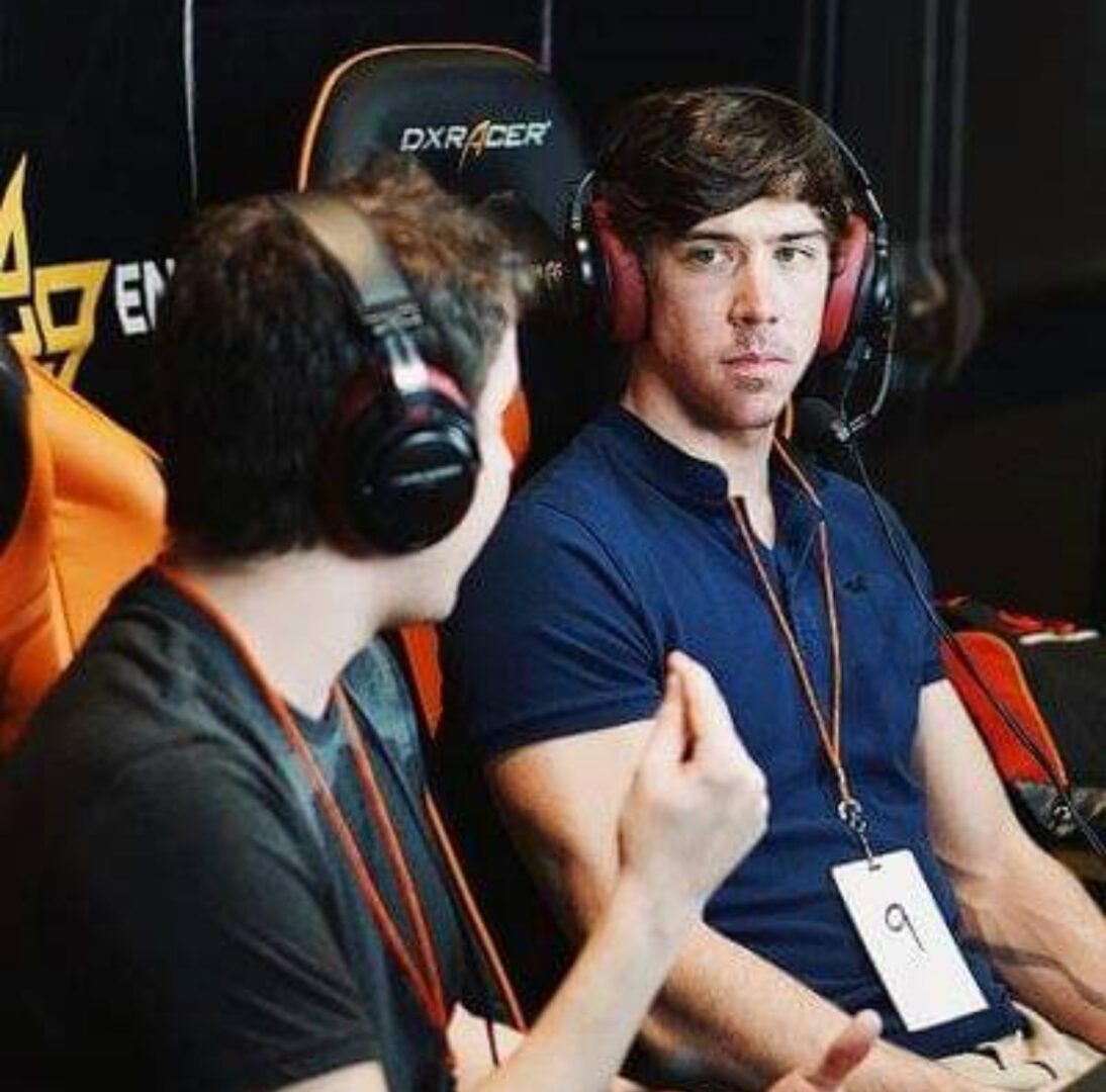 People discussing strategies during gaming event