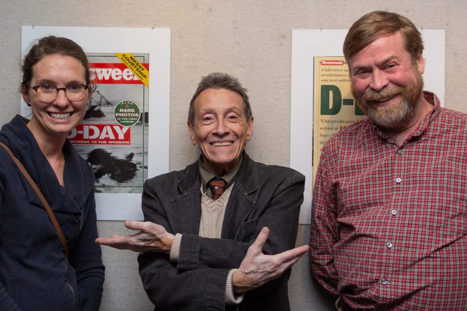 Group posing with historical magazine covers