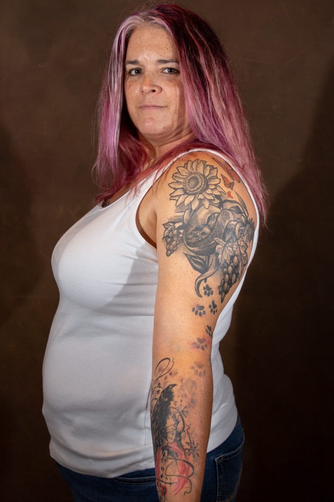Woman with colorful tattoos and pink hair