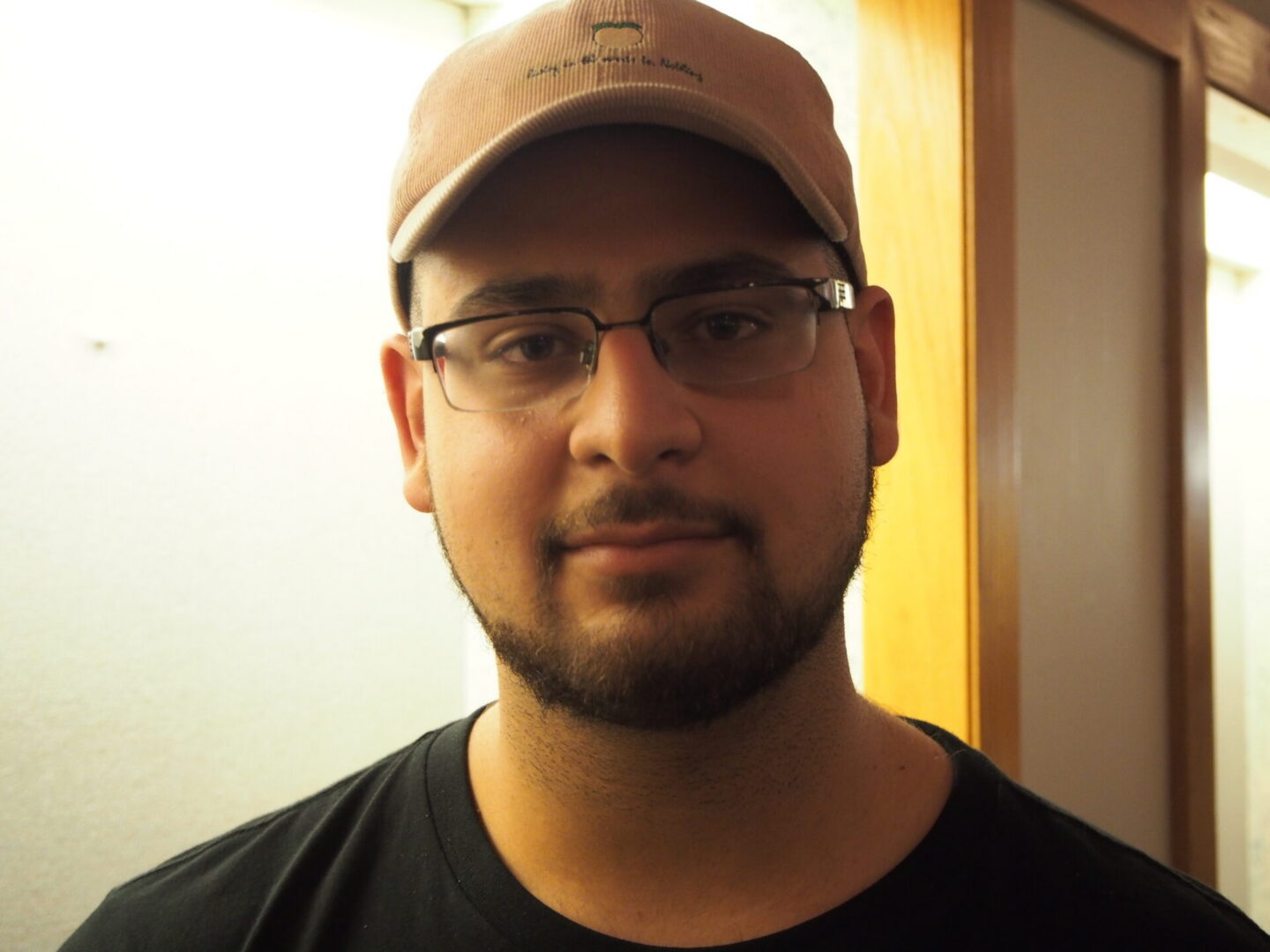 Person with beard, glasses, and cap