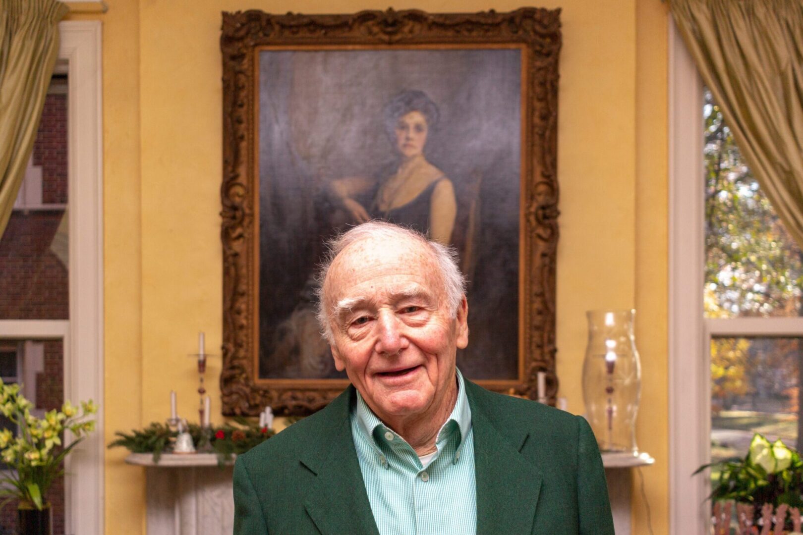 Happy senior standing in elegant room