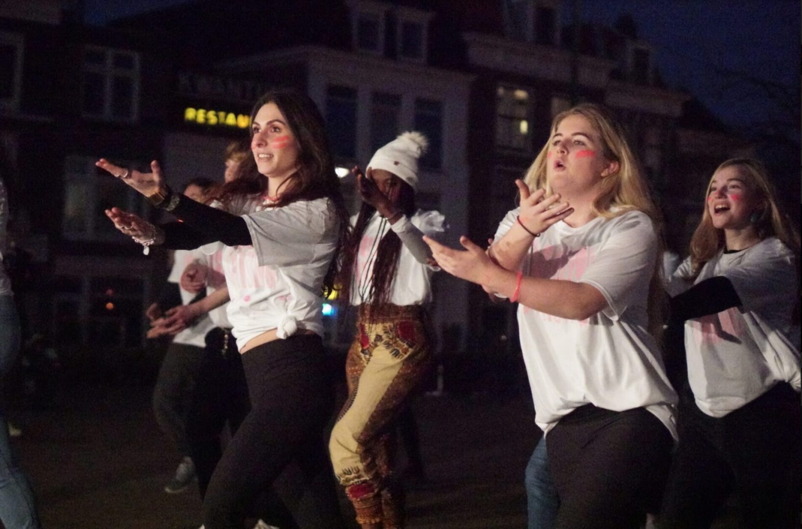 Group dancing energetically at night