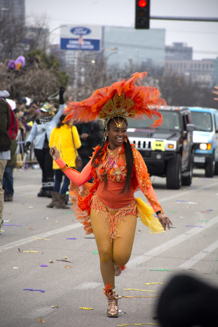 Carnival dancer in vibrant orange costume