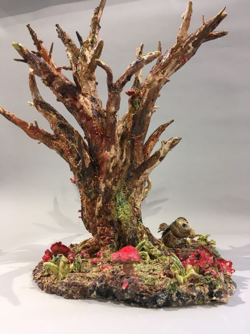 Tree sculpture featuring colorful natural elements