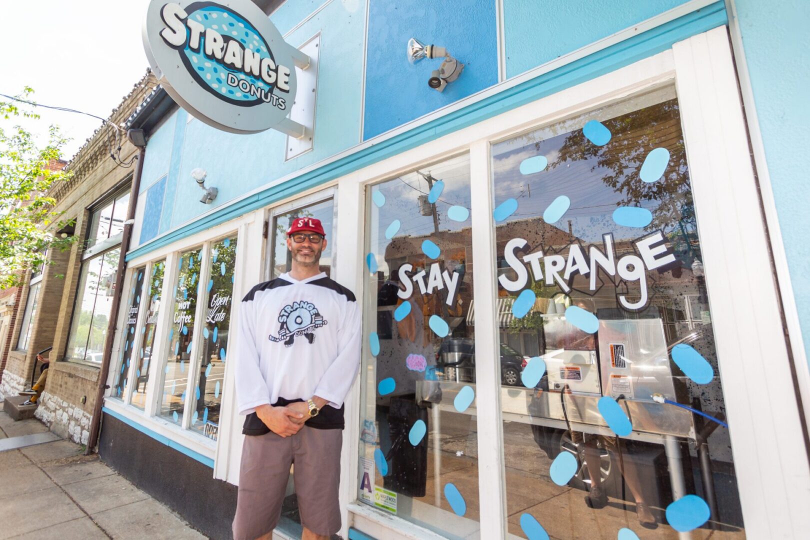 Man stands outside donut shop