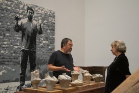 People examining sculptures in museum