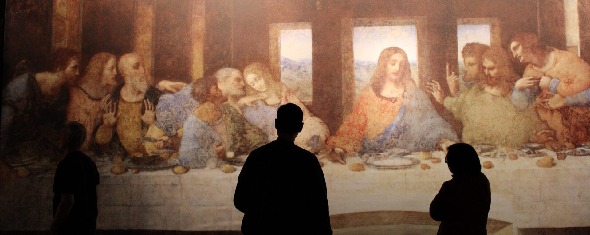 People viewing "The Last Supper" painting