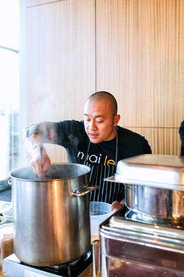 Person preparing food in professional setting.