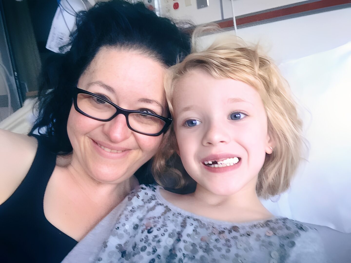 Woman and child smiling together in hospital