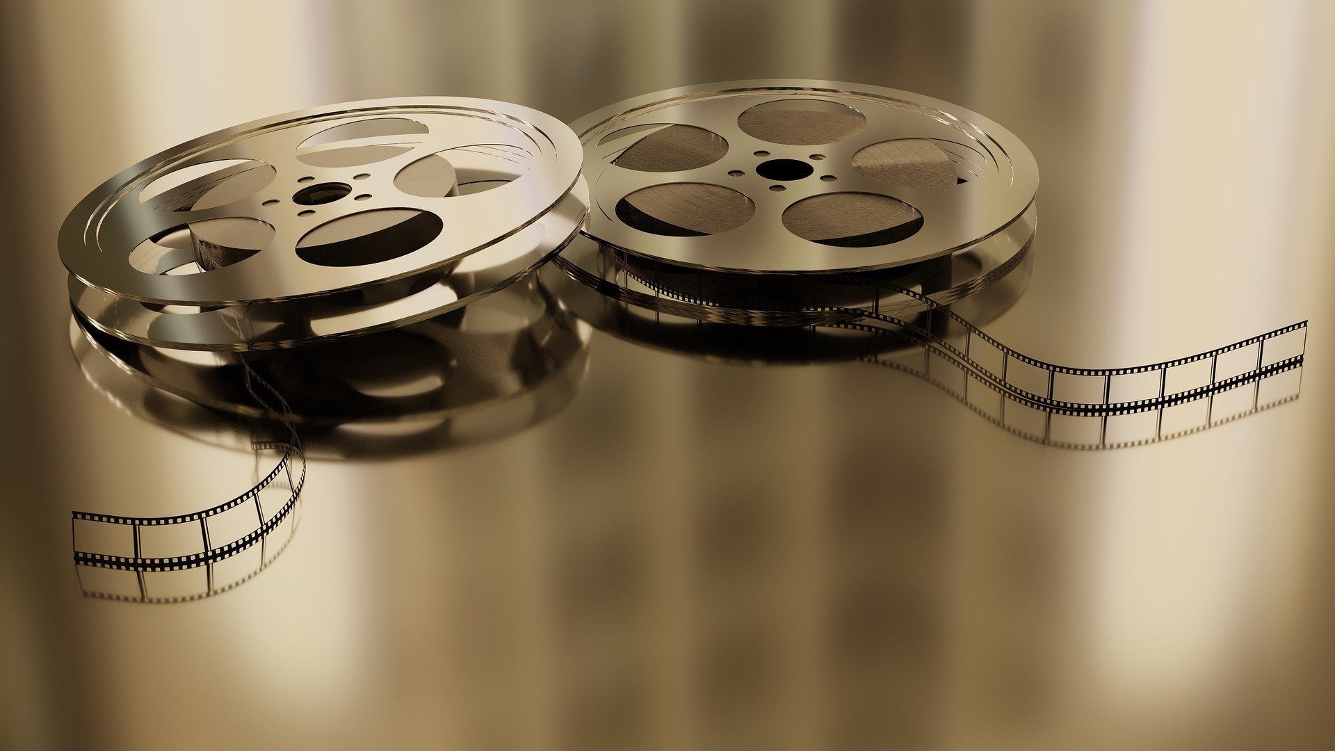 Two metal movie reels with filmstrip
