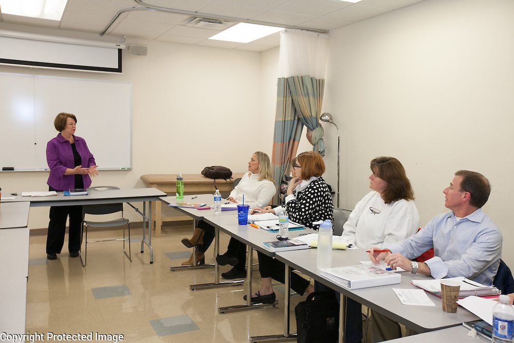 Woman presenting to attentive audience in classroom