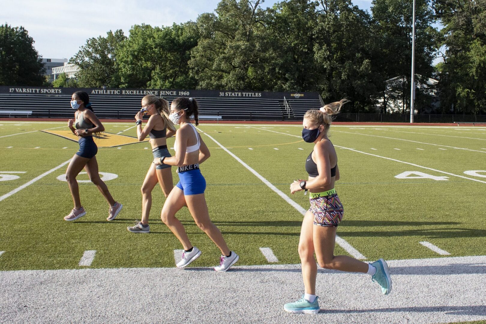 Group jogging on sports field