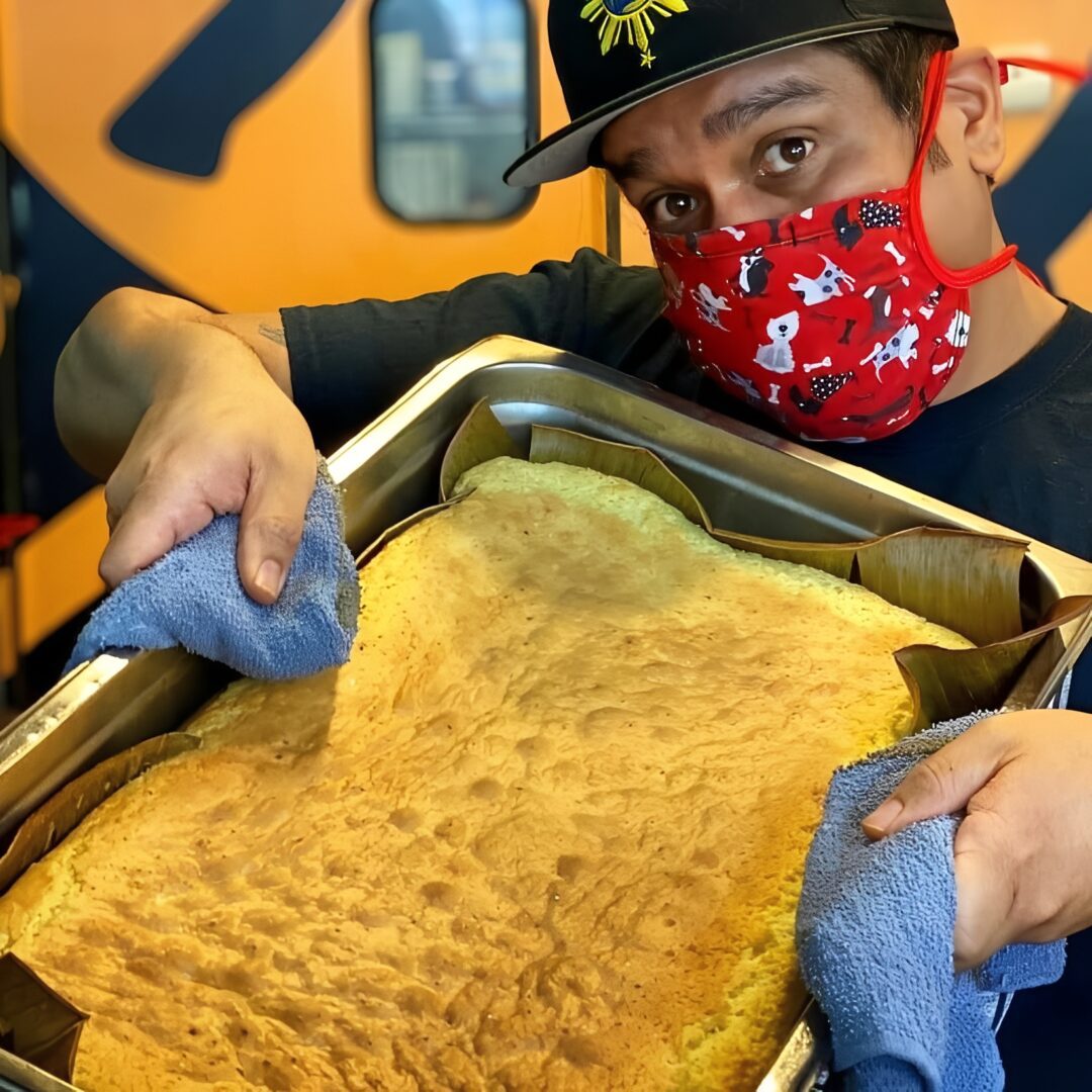 Man holding large baked cake