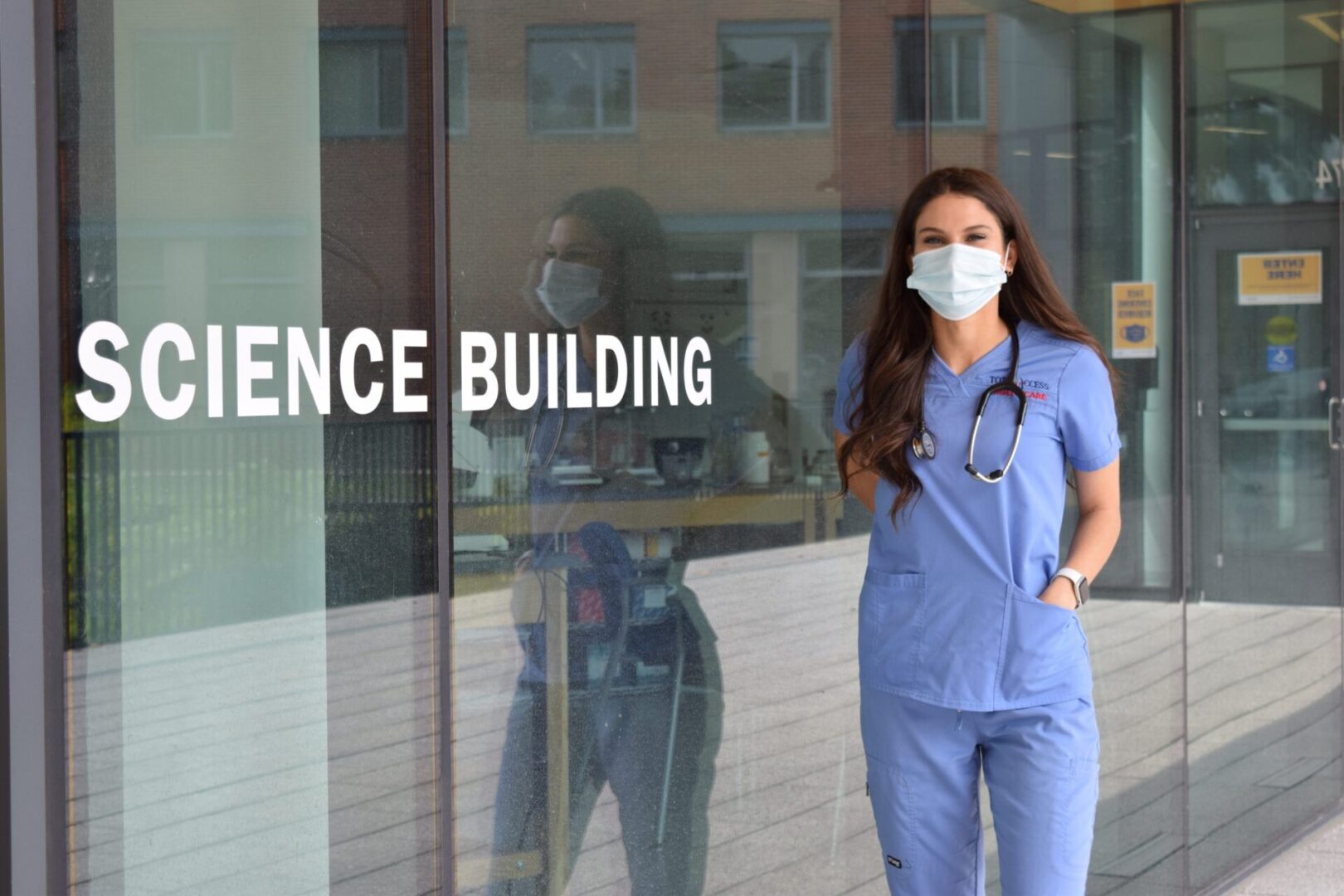 Healthcare worker wearing mask near building