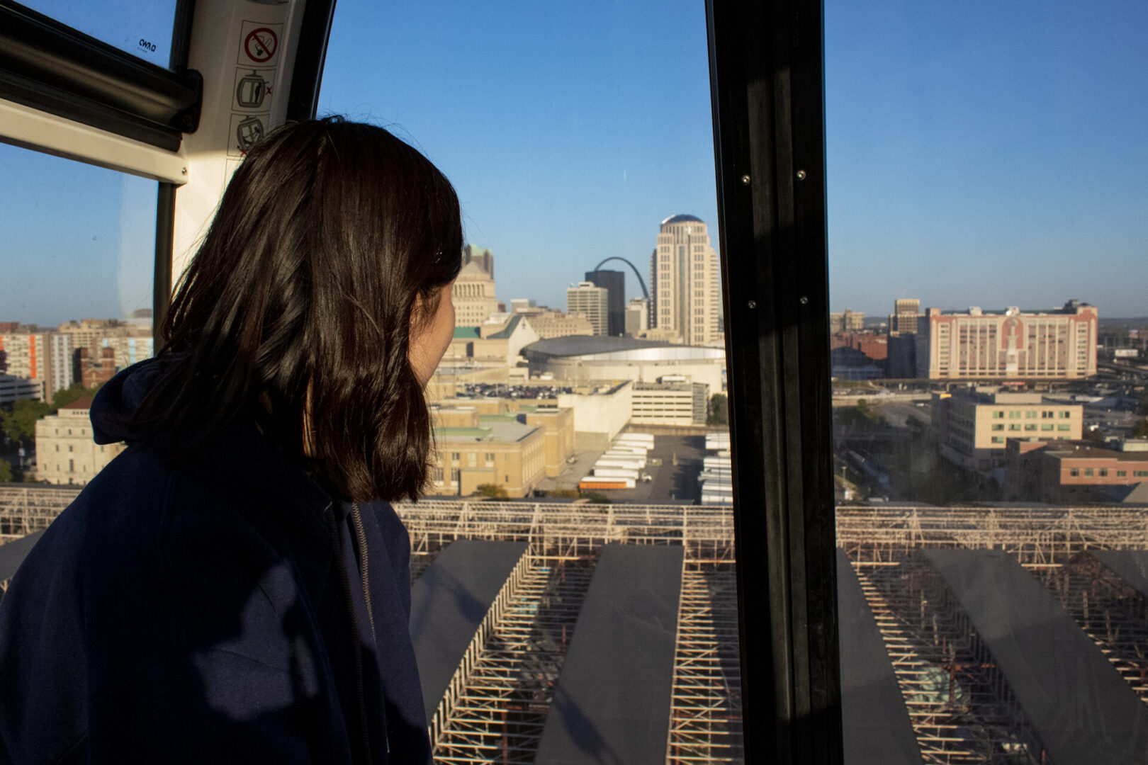 Person in gondola overlooking cityscape