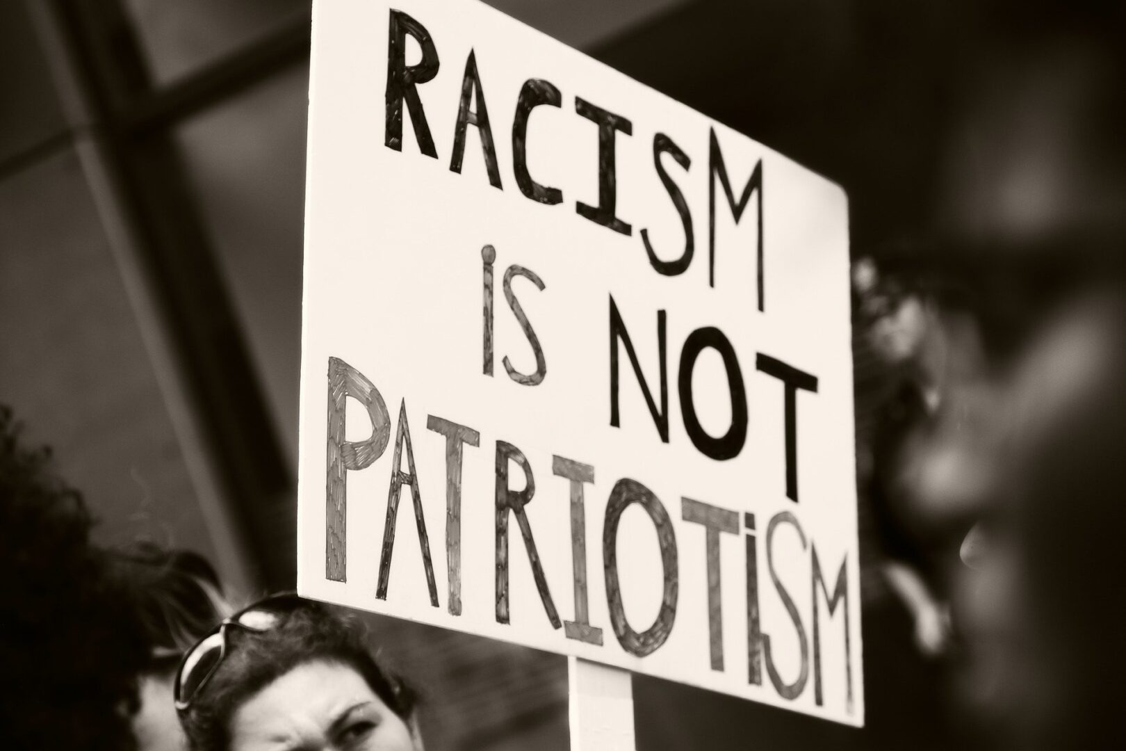 Sign reads: Racism is not patriotism