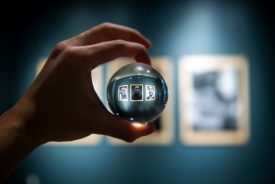 Hand holding crystal ball in gallery