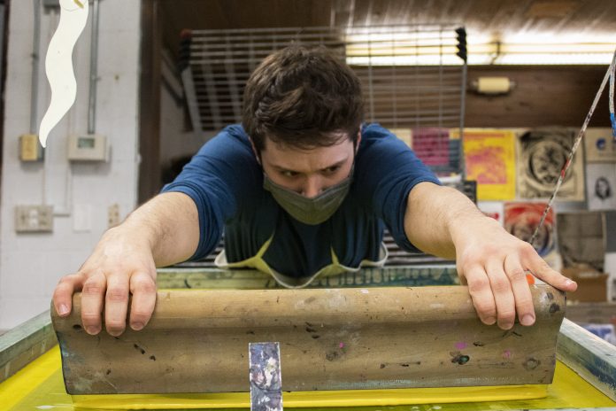 Man focused on screen printing