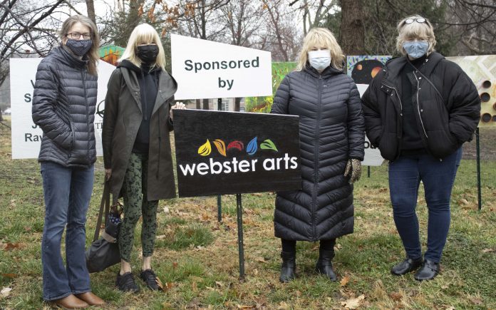 People in masks at Webster Arts event