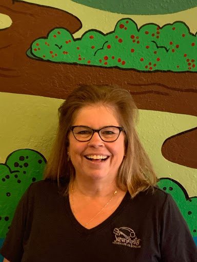 Smiling woman in glasses and black shirt