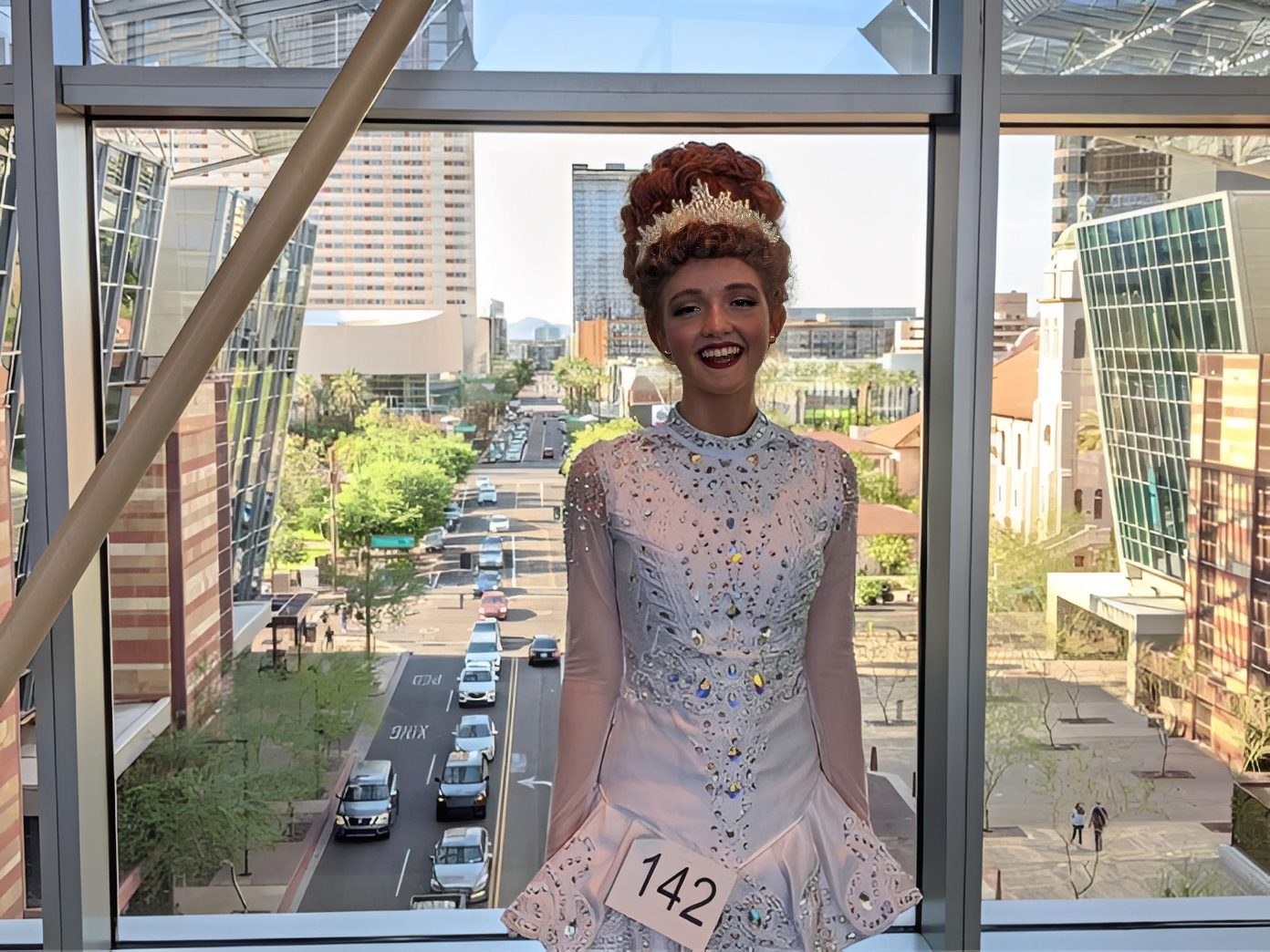 Woman in competition attire, city backdrop
