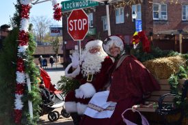 Santa and Mrs. Claus on decorated bench